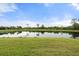 A tranquil pond surrounded by lush greenery, creating a serene natural setting at 5240 Bentgrass Way, Bradenton, FL 34211