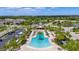 Resort style pool with palm tree island and a community clubhouse surrounded by lush landscaping in a beautiful neighborhood at 5240 Bentgrass Way, Bradenton, FL 34211