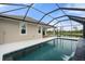 Inviting screened pool with waterfall feature, and beautiful water views at 5240 Bentgrass Way, Bradenton, FL 34211