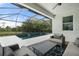Relaxing outdoor patio with a screened-in pool and gorgeous water views at 5240 Bentgrass Way, Bradenton, FL 34211