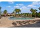 Resort-style pool with sun loungers and palm trees creating a relaxing atmosphere at 5240 Bentgrass Way, Bradenton, FL 34211
