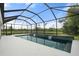 Screened pool with waterfall features overlooking a scenic pond, creating a serene outdoor oasis for relaxation at 5240 Bentgrass Way, Bradenton, FL 34211