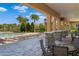 Covered patio with stone pillars overlooking the pool and palm trees at 5240 Bentgrass Way, Bradenton, FL 34211