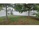Large backyard offering a white vinyl fence for privacy and beautiful trees at 5325 Murdock Ave, Sarasota, FL 34231
