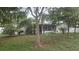 Backyard view featuring a screened-in patio and lush greenery, perfect for relaxation at 5325 Murdock Ave, Sarasota, FL 34231