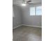 A gray bedroom with a ceiling fan and hardwood floors at 5325 Murdock Ave, Sarasota, FL 34231