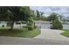 Inviting home featuring a long driveway, two-car garage and lush landscaping enhancing curb appeal at 5325 Murdock Ave, Sarasota, FL 34231