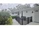 Quaint covered porch with black railing and a cozy bench offer a relaxing outdoor space at 5325 Murdock Ave, Sarasota, FL 34231