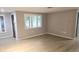 Spacious living room with hardwood floors and ample natural light from large windows at 5325 Murdock Ave, Sarasota, FL 34231
