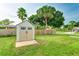 Backyard shed with light tan color, a concrete foundation, and green surroundings at 5329 Ansonia Ter, North Port, FL 34287