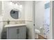 Bathroom featuring a gray vanity with a marble style accent wall and a toilet at 5329 Ansonia Ter, North Port, FL 34287
