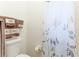 A close up of the toilet and shower curtain featuring brown decorative towels at 5329 Ansonia Ter, North Port, FL 34287