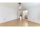 A bedroom with wood-look floors leading to living area and bathroom at 5329 Ansonia Ter, North Port, FL 34287