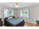 Bedroom featuring wood-look flooring and two windows providing natural light at 5329 Ansonia Ter, North Port, FL 34287