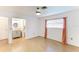 Bright bedroom featuring a ceiling fan, wood-look floors, and a bathroom at 5329 Ansonia Ter, North Port, FL 34287