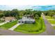 Charming one-story home featuring a long driveway and a lush green lawn at 5329 Ansonia Ter, North Port, FL 34287