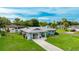 Beautiful single-story home with an attached garage and a well-maintained lawn on a sunny day at 5329 Ansonia Ter, North Port, FL 34287