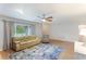Bright living room featuring a large window and modern ceiling fan at 5329 Ansonia Ter, North Port, FL 34287