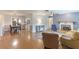 Open-concept living room with a fireplace, dining area, and ample natural light at 5329 Ansonia Ter, North Port, FL 34287