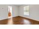Bright bedroom features a bathroom, window, and beautiful wood floors at 5356 Royal Palm Ave # 5356, Sarasota, FL 34234