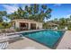 Community pool featuring a covered patio and lounge area for relaxation at 5356 Royal Palm Ave # 5356, Sarasota, FL 34234