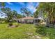 Charming single story home with a well-manicured lawn and mature trees enhancing its curb appeal at 5356 Royal Palm Ave # 5356, Sarasota, FL 34234