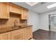 This kitchen features wooden cabinets, granite countertops, tiled backsplash, and stainless steel sink at 5356 Royal Palm Ave # 5356, Sarasota, FL 34234