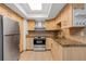 Modern kitchen with stainless steel appliances, light wooden cabinets, and a bright skylight at 5356 Royal Palm Ave # 5356, Sarasota, FL 34234