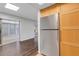The kitchen boasts stainless steel refrigerator, wooden cabinets, and easy access to sunroom at 5356 Royal Palm Ave # 5356, Sarasota, FL 34234