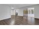 Contemporary living space featuring wood floors, sliding glass doors to sunroom, and sleek white walls at 5356 Royal Palm Ave # 5356, Sarasota, FL 34234