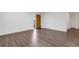 Bright and airy living room showcasing modern wood floors and a unique solid wood front door at 5356 Royal Palm Ave # 5356, Sarasota, FL 34234