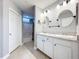Bright bathroom with a double sink vanity, granite countertops, and a separate shower at 5459 Bentgrass Dr # 2-116, Sarasota, FL 34235