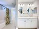 Bathroom with granite countertops, dual sinks, and a view of the bathtub at 5459 Bentgrass Dr # 2-116, Sarasota, FL 34235