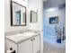 Bathroom view features a vanity with a granite countertop, and a doorway view of the home's stairlift at 5459 Bentgrass Dr # 2-116, Sarasota, FL 34235
