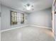 Bedroom featuring tropical print curtains, tile floors, fan, and a view of an entryway at 5459 Bentgrass Dr # 2-116, Sarasota, FL 34235