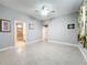 Bedroom with tile floors, ceiling fan, and multiple entryways to other parts of the home at 5459 Bentgrass Dr # 2-116, Sarasota, FL 34235