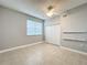 Bedroom featuring tiled floors, a window with blinds, ceiling fan, and a double door closet at 5459 Bentgrass Dr # 2-116, Sarasota, FL 34235