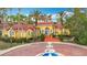 Las Palmas Clubhouse with lush landscaping and a fountain at 5459 Bentgrass Dr # 2-116, Sarasota, FL 34235