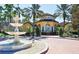 Las Palmas Clubhouse with lush landscaping and a fountain at 5459 Bentgrass Dr # 2-116, Sarasota, FL 34235