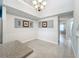 Bright dining area with tile flooring, chandelier, and views to the entryway at 5459 Bentgrass Dr # 2-116, Sarasota, FL 34235