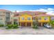 Bright townhome featuring a red tile roof, garage, and well-maintained landscaping at 5459 Bentgrass Dr # 2-116, Sarasota, FL 34235