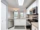 Updated kitchen with stainless steel appliances, granite countertops, and ample natural light at 5459 Bentgrass Dr # 2-116, Sarasota, FL 34235