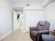 Cozy living room area featuring neutral paint, tile floors, and a comfortable recliner chair at 5459 Bentgrass Dr # 2-116, Sarasota, FL 34235