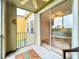 Relax on this bright patio with fan, view of living room, and exterior views at 5459 Bentgrass Dr # 2-116, Sarasota, FL 34235
