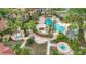 Aerial view of a landscaped resort pool with lounge chairs, palm trees, and jacuzzi at 5459 Bentgrass Dr # 2-116, Sarasota, FL 34235