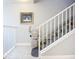 Stairway with white banisters and a stair lift, offering accessibility and ease of mobility at 5459 Bentgrass Dr # 2-116, Sarasota, FL 34235