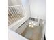 Wide angle view looking down the stairwell, featuring tile floors, a chandelier, and white railings at 5459 Bentgrass Dr # 2-116, Sarasota, FL 34235
