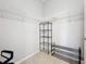 A walk-in closet with wire shelving, and a metal rack in a corner of the room at 5459 Bentgrass Dr # 2-116, Sarasota, FL 34235