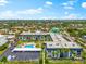 An aerial view showing the condo complex, pool, parking, landscaping, and the surrounding neighborhood at 5600 Beach Way Dr # 201, Sarasota, FL 34242