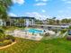 Aerial view of the community pool and amenity area, with lush landscaping at 5600 Beach Way Dr # 201, Sarasota, FL 34242